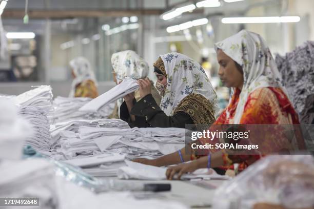 Garment workers work at the Surma Garments Limited in Savar,.