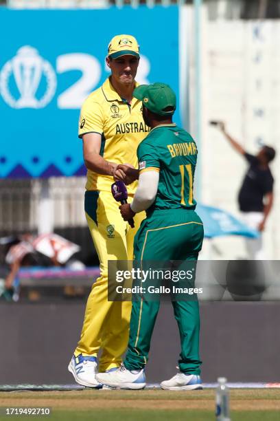 Australia's captain Pat Cummins and Temba Bavuma of South Africa at the toss during the ICC Men's Cricket World Cup 2023 match between Australia and...