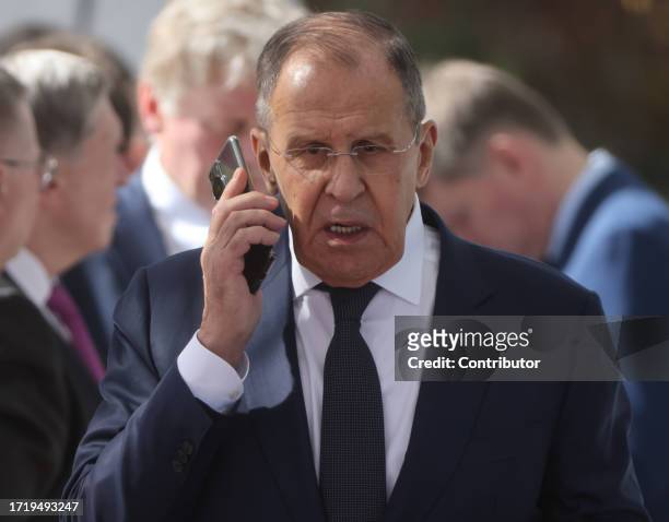 Russian Foreign Minister Sergei Lavrov speaks on the mobile during a welcoming ceremony during their meeting at the Ala-Archa State Residence on...