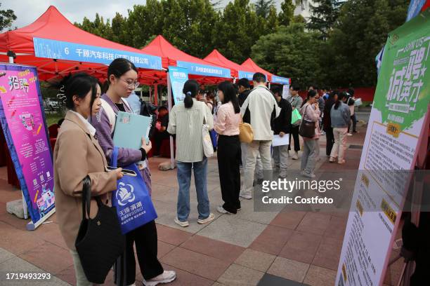 College students look for suitable positions at a recruitment site in Lianyungang, Jiangsu Province, China, Oct 12, 2023.