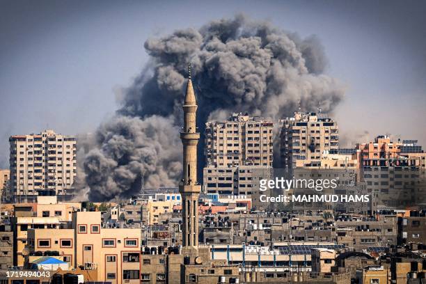 Smoke plumes billow during Israeli air strikes in Gaza City on October 12, 2023 as raging battles between Israel and the Hamas movement continue for...