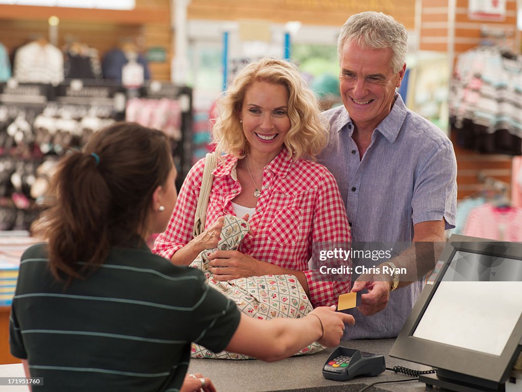 Cashier scanning couples purchases in store