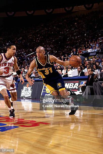 Reggie Miller of the Indiana Pacers drives to the basket against John Starks of the New York Knicks at Madison Square Garden in 1995 in New York...