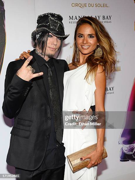 Guitarist Dj Ashba of Guns N' Roses and Nathalia Henao arrive at the world premiere of "Michael Jackson ONE by Cirque du Soleil" at THEhotel at...