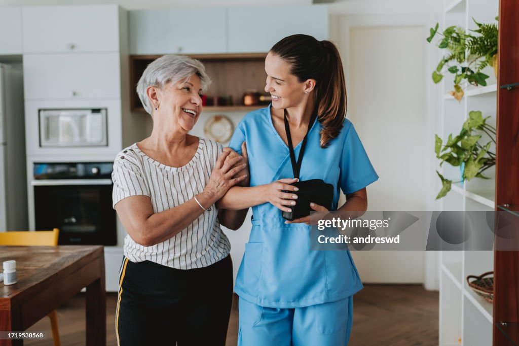 Healthcare professional home care senior patient arm in arm