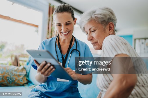 Home care healthcare professional using digital tablet Home care healthcare professional using digital tablet