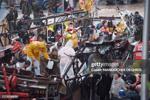 Israeli rescue teams search for bodies of victims inside the wreckage of a bus which was destroyed on March 3, 1996 by a suicide bomber in central...