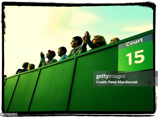 Tennis fans watch the action from court 15 at The Wimbledon Lawn Tennis Championships on June 26, 2013 in London, England.