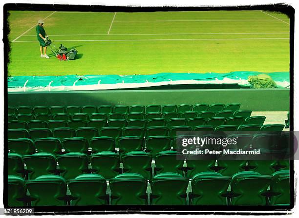 Groundsman cuts the Centre Court grass at The Wimbledon Lawn Tennis Championships on June 27, 2013 in London, England.