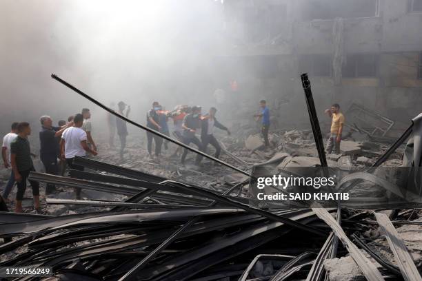 Graphic content / A Palestinian is stretchered away following an Israeli strike, as battles between Israel and the Hamas movement continue for the...