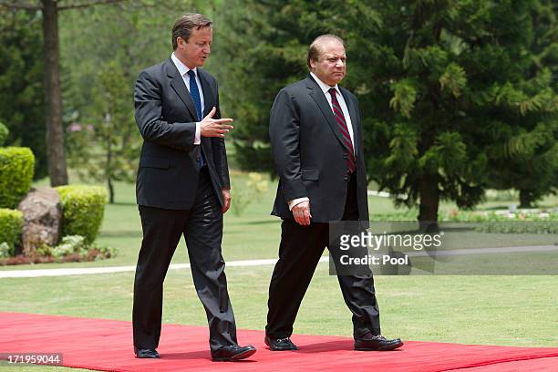 British Prime Minister David Cameron walks with Pakistani Prime Minister Nawaz Sharif at the Prime Minister's house on June 30, 2013 in Islamabad,...