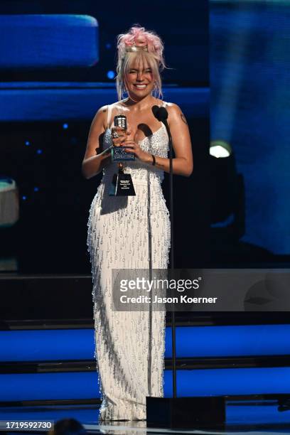 Karol G speaks onstage during the 2023 Billboard Latin Music Awards at Watsco Center on October 05, 2023 in Coral Gables, Florida.