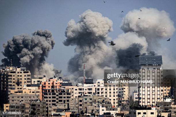 Smoke plumes billow during Israeli air strikes in Gaza City on October 12, 2023 as raging battles between Israel and the Hamas movement continue for...