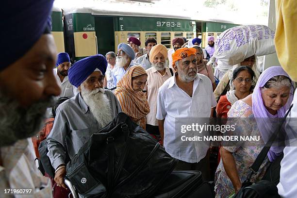 Indian Sikh pilgrims returning from Pakistan arrive at the Attari railway station, some 35 kms from Amritsar, on June 30, 2013. Hundreds of Indian...