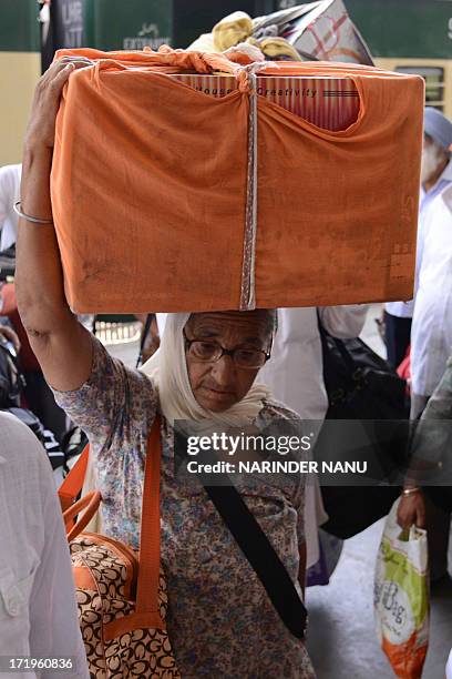 Indian Sikh pilgrims returning from Pakistan arrive at the Attari railway station, some 35 kms from Amritsar, on June 30, 2013. Hundreds of Indian...