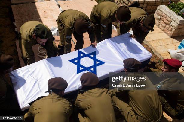 Soldiers carry the coffin of Dor Yarhi, who was killed in a battle with Palestinian militants near the Israeli border with the Gaza Strip during his...