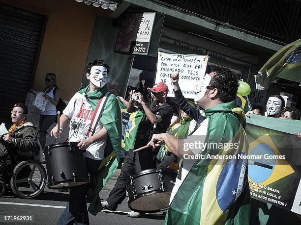 In june 22 brazilians wearing anonymous masks were marching against laws that protects corrupted politicians in congress. "Come to the streets!"...