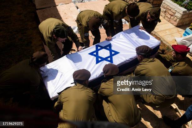 Soldiers carry the coffin of Dor Yarhi, who was killed in a battle with Palestinian militants near the Israeli border with the Gaza Strip during his...
