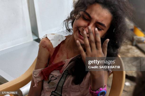 Graphic content / An injured girl reacts as she waits at the hospital to be checked, as battles between Israel and the Hamas movement continue for...