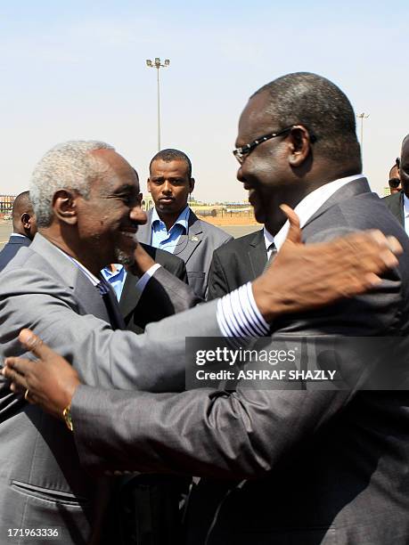 Sudan's Vice President Ali Osman Taha greets his South Sudanese counterpart Riek Machar upon the latter's arrival at Khartoum ariport on June 30,...