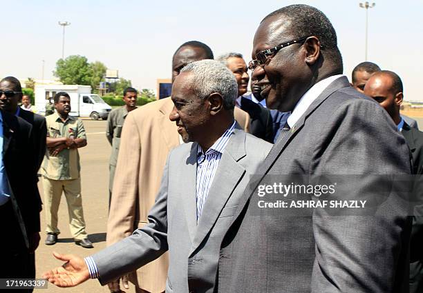 Sudan's Vice President Ali Osman Taha welcomes his South Sudanese counterpart Riek Machar upon the latter's arrival at Khartoum ariport on June 30,...