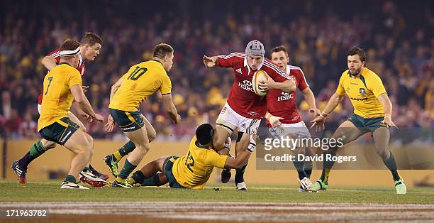 Jonathan Davies of the Lions is held by Christian Leali'ifano during game two of the International Test Series between the Australian Wallabies and...