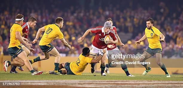 Jonathan Davies of the Lions is held by Christian Leali'ifano during game two of the International Test Series between the Australian Wallabies and...