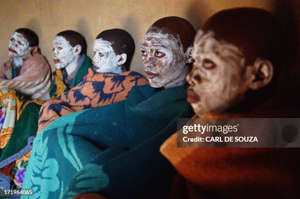 Boys from the Xhosa tribe who have undergone a circumcision ceremony sing inside a hut near Qunu on June 30, 2013. Qunu is where former South African...