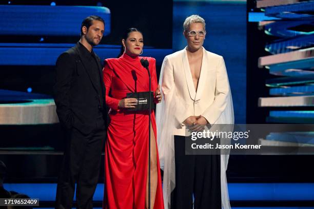 Christopher Von Uckermann, Maite Perroni and Christian Chávez speak onstage during the 2023 Billboard Latin Music Awards at Watsco Center on October...