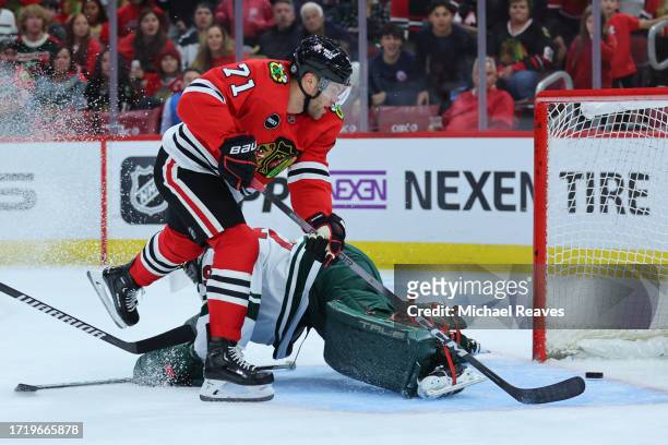 Taylor Hall of the Chicago Blackhawks scores a goal past Marc-Andre Fleury of the Minnesota Wild during the second period of a preseason game at the...