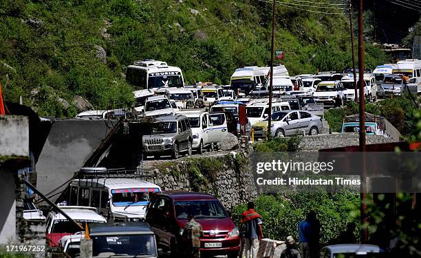 Stranded cars along the river Alaknanda since the day of flash flood as the road to Joshimath has been washed away at Govind Ghat on June 30 2013 in...