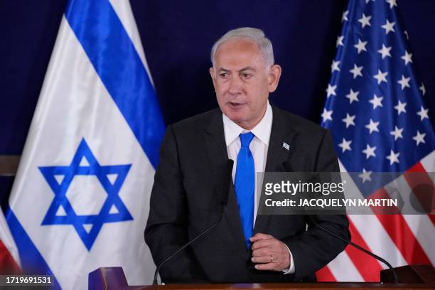 Israeli Prime Minister Benjamin Netanyahu gives statements to the media inside The Kirya, which houses the Israeli Defence Ministry, after their...