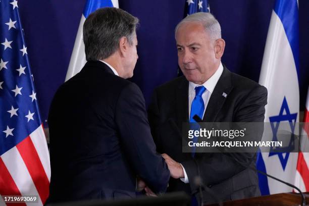Israeli Prime Minister Benjamin Netanyahu shakes hands with US Secretary of State Antony Blinken during statements to the media inside The Kirya,...