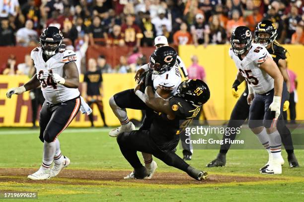 Jonathan Allen of the Washington Commanders sacks Justin Fields of the Chicago Bears during the third quarter at FedExField on October 05, 2023 in...