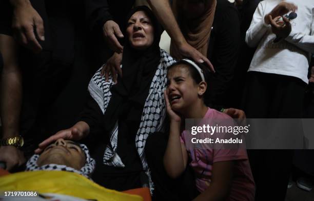 Relatives of 16 year old Muennis Zeyadat, who was killed when Israeli soldiers opened fire, mourn during his funeral in Bani Na'im district of...