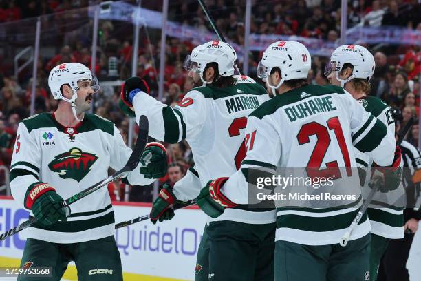 Pat Maroon of the Minnesota Wild high fives teammates after scoring a goal against the Chicago Blackhawks during the third period of a preseason game...