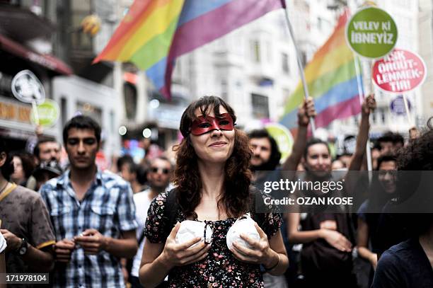 Woman shows a bra made from a gas mask during during a gay parade on Istiklal Street, the main shopping corridor on June 30, 2013 in Istanbul during...