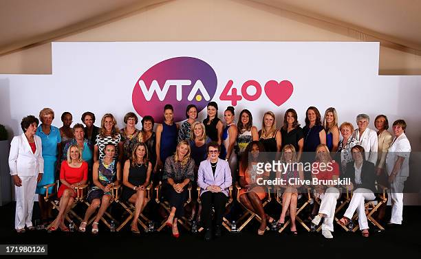Chairman and CEO of the Women's Tennis Association Stacey Allaster poses on stage with former and current tennis players including former and the...