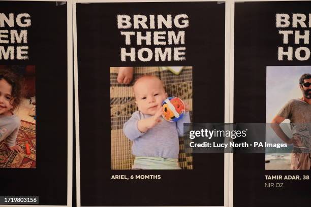 Pictures of loved ones who have been captured by Hamas on display during a Defend Israeli Democracy UK press conference at Plaza Westminster Bridge...