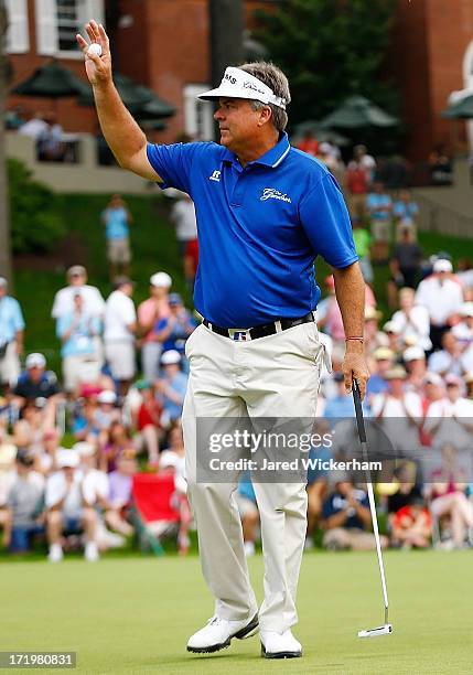 Kenny Perry celebrates on the 18th green in the final round after winning the 2013 Constellation Senior Players Championship at Fox Chapel Golf Club...