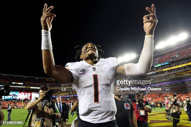 Justin Fields of the Chicago Bears celebrates after defeating the Washington Commanders, 40-20, following an NFL football game between the Washington...