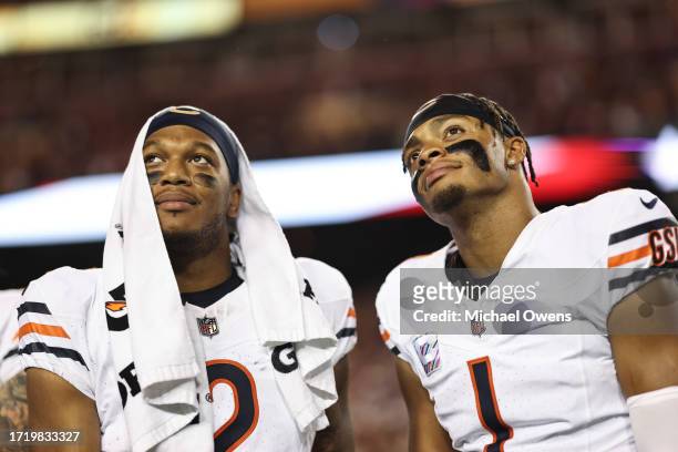 Moore of the Chicago Bears and Justin Fields of the Chicago Bears react as they look on prior to an NFL football game between the Washington...