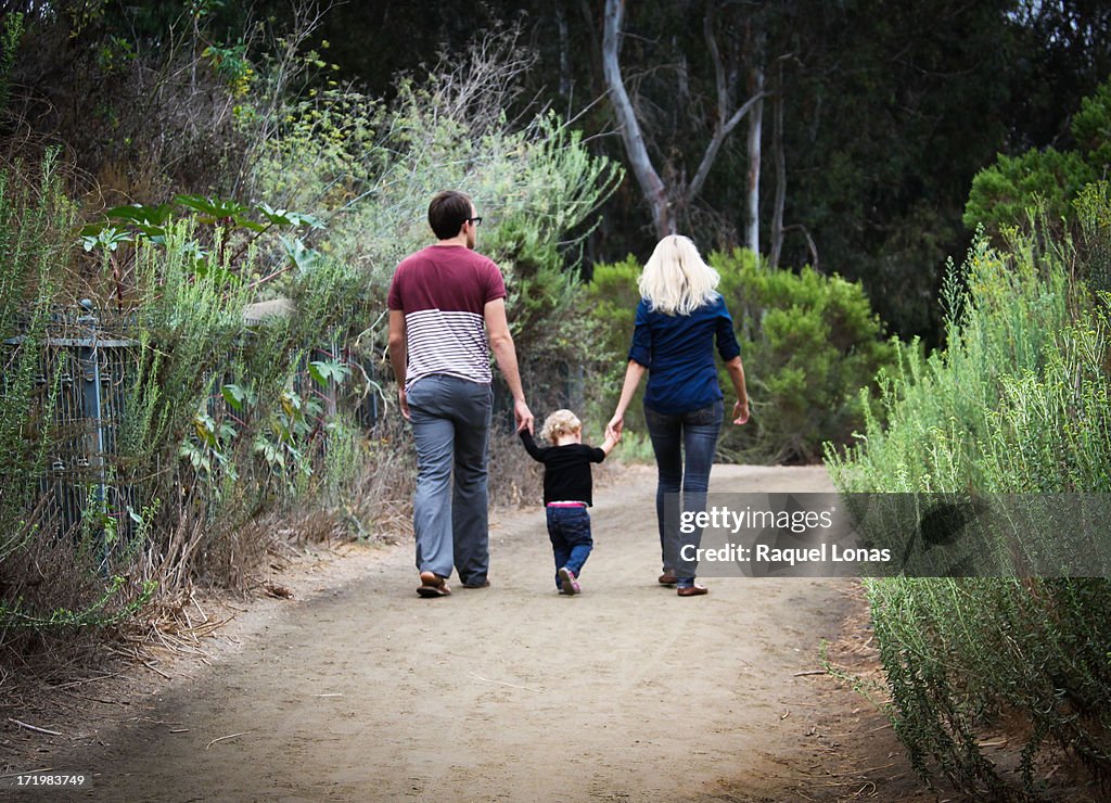 Young couple with toddler walking away
