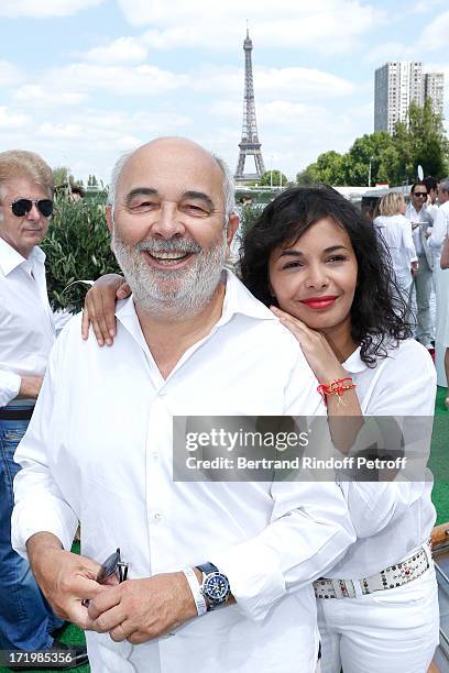 Gerard Jugnot and his companion Saida Jawad attend 'Brunch Blanc' hosted by Groupe Barriere for Sodexho with a cruise in Paris on June 30 France.