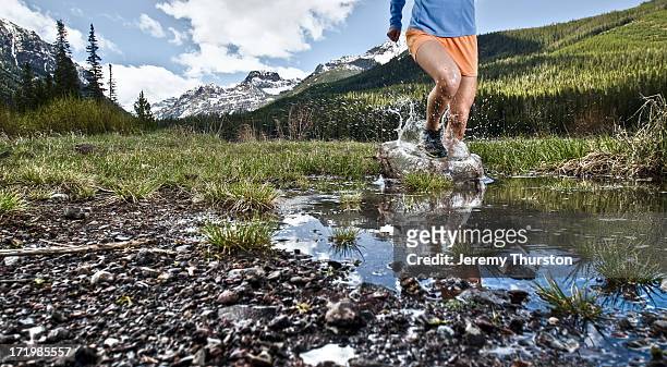 young woman running through water - gallatin county montana stock pictures, royalty-free photos & images
