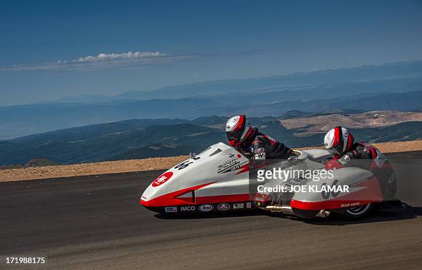 Japanese rider Masahito Watanabe and his copilot cross the finish line at the summit of Pikes Peak mountain during The Pikes Peak International Hill...