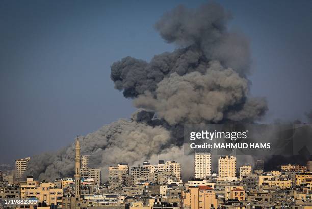 Smoke billows during Israeli air strikes in Gaza City on October 12, 2023 as raging battles between Israel and the Hamas movement continue for the...