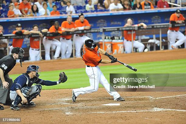 Jeff Mathis of the Miami Marlins hits a grand slam during the ninth inning against the San Diego Padres at Marlins Park on June 30, 2013 in Miami,...