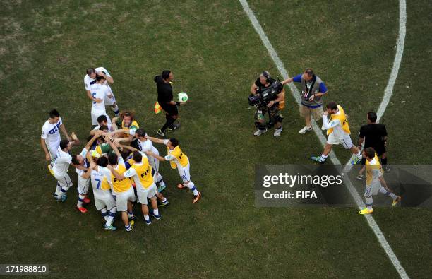 In this handout image provided by FIFA Gianluigi Buffon of Italy celebrates with his team-mates after saving the penalty of Walter Gargano of Uruguay...