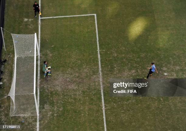 In this handout image provided by FIFA Gianluigi Buffon of Italy saves the penalty of Martin Caceres of Uruguay during a shootout during the FIFA...